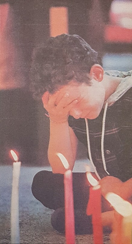 Krista Mumby, 8, Graham Niven's niece, is overcome with emotion during a candelight ceremony only a