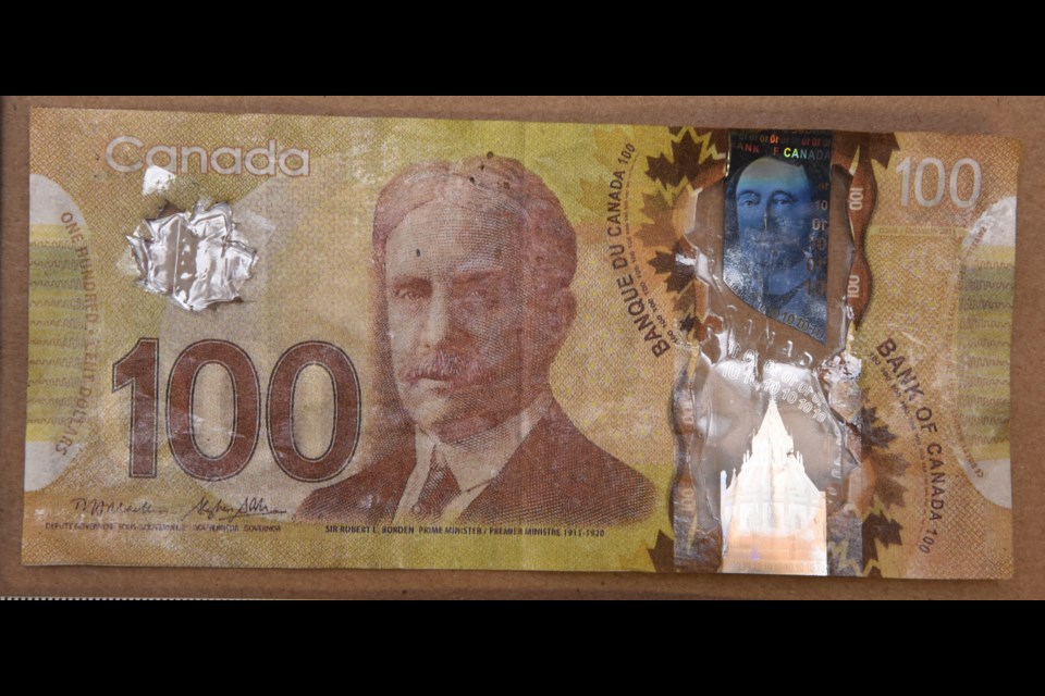 One of the fake bills found in Saanich. The transparent areas have been cut out of legitimate bills of lesser value, and then taped or glued into a forged bill.