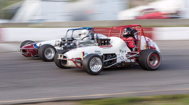 The cars driven by Al Levien of Chilliwack, foreground, and Jeff Cook of Colbert, WA race around the track at PGARA Motor Speedway on Wednesday evening during West Coast Vintage Racing Association sprint car action. Citizen Photo by James Doyle
