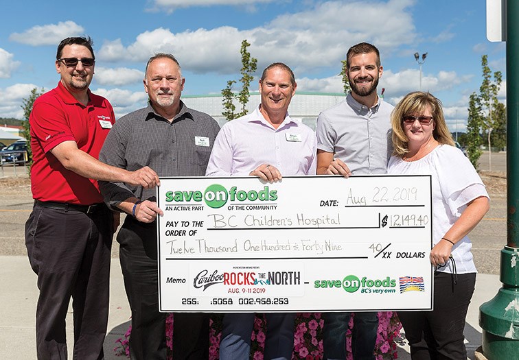 From left, Save On Foods store managers Rejean Perrault (Parkwood), Neil Guardiero (College Heights), Brain Gandy (Spruceland), Kyle Sampson, Manager of Northern B.C. for Pacific Western Brewing, and Tracy Shaw, Event Manager for CN Centre pose for photo during a cheque presentation on Thursday afternoon at CN Centre. Save On Foods donated $12, 149.40 to the B.C. Children’s Hospital that was raised from their barbeque during the three days of Cariboo Rocks The North. Citizen Photo by James Doyle