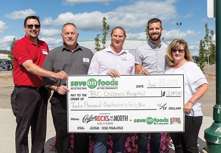 From left, Save On Foods store managers Rejean Perrault (Parkwood), Neil Guardiero (College Heights), Brain Gandy (Spruceland), Kyle Sampson, Manager of Northern B.C. for Pacific Western Brewing, and Tracy Shaw, Event Manager for CN Centre pose for photo during a cheque presentation on Thursday afternoon at CN Centre. Save On Foods donated $12, 149.40 to the B.C. Children’s Hospital that was raised from their barbeque during the three days of Cariboo Rocks The North. Citizen Photo by James Doyle