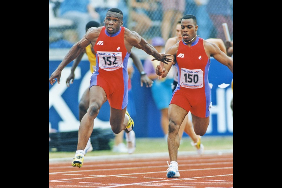 Canada's Bruny Surin, left, takes the baton from Carlton Chambers for the anchor leg of the 4X100 relay at the 1994 Commonwealth Games. Canada won gold.