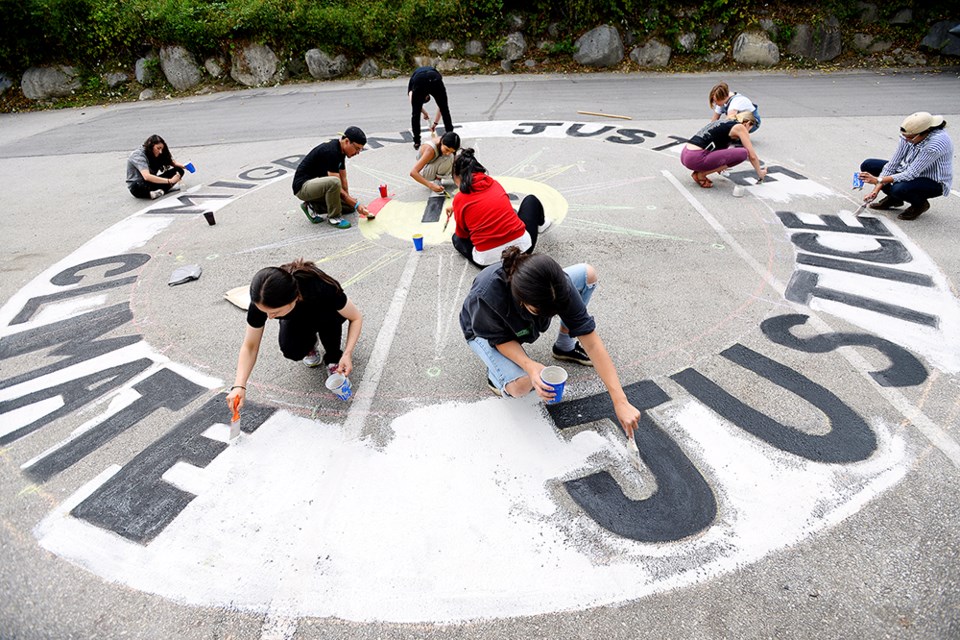 Greenpeace held a workshop on how to paint street murals using clay mixed with water and tempura children's paint ahead of the federal election, as part of a co-ordinated national day of action on Oct. 5 to promote a Green New Deal.
