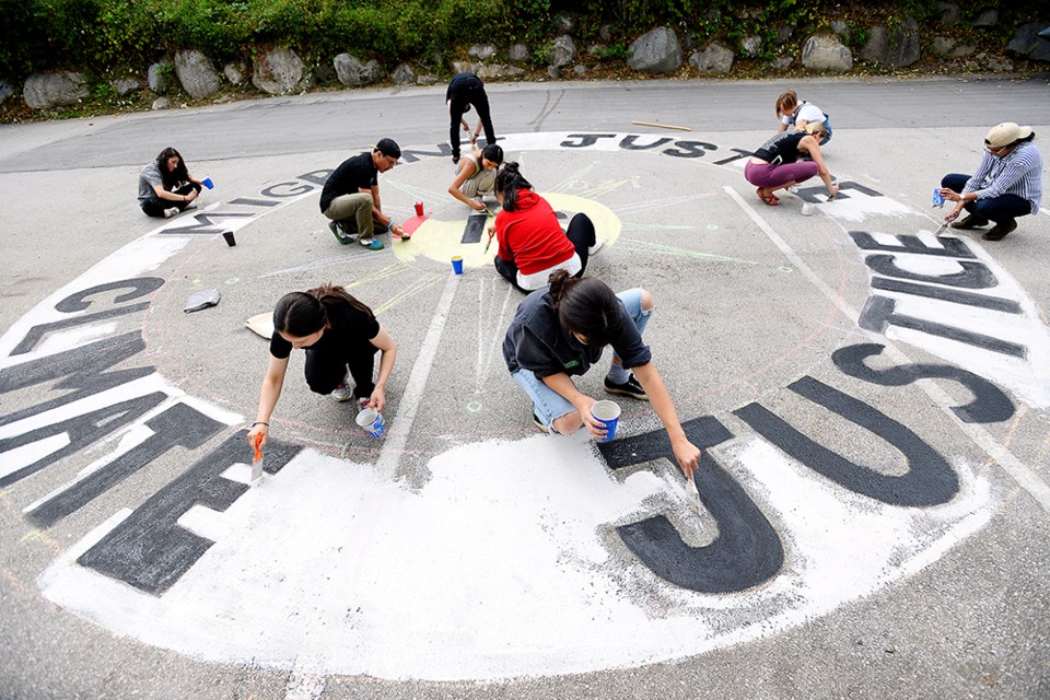 Greenpeace held a workshop on how to paint street murals using clay mixed with water and tempura children's paint ahead of the federal election, as part of a co-ordinated national day of action on Oct. 5 to promote a Green New Deal.