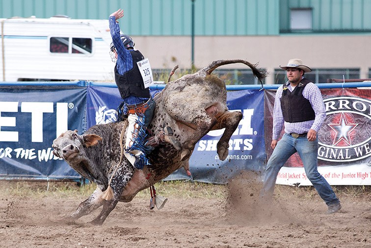 Brekan Loewen of Fort St. John holds on tight to a bull on Sunday afternoon at the Exhibition Park rodeo grounds while participating in the senior bull riding competition of the High School Rodeos of B.C. Prince George Rodeo. Citizen Photo by James Doyle