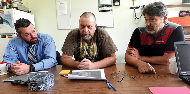 Cpl. Martin Neveu with the Mackenzie detachment of the RCMP , Knut Herzog, search manager with Mackenzie SAR and Dale Parker president of Mackenzie SAR talk about the search for George Hazard-Benoit, a four-year-old Mackenzie boy who went missing while berry picking with his family near Lions Lake, south of Mackenzie on Saturday afternoon. He was found safe and uninjured Sunday evening and has been reunited with his parents. Citizen photo by Brent Braaten