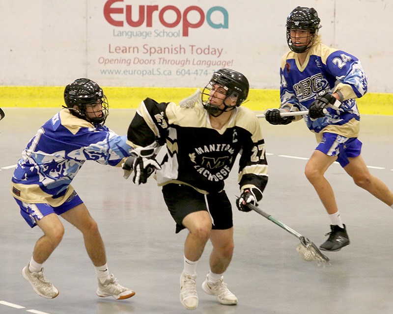 MARIO BARTEL/THE TRI-CITY NEWS
Manitoba forward Reese Whyte tries to squeeze between a pair of Team BC defenders, David Charney and Joel McCormick, in the second period of their Midget game at the Canadian minor box lacrosse championships, last Friday at the Poirier Sport and Leisure Complex. BC won the game, 15-2.