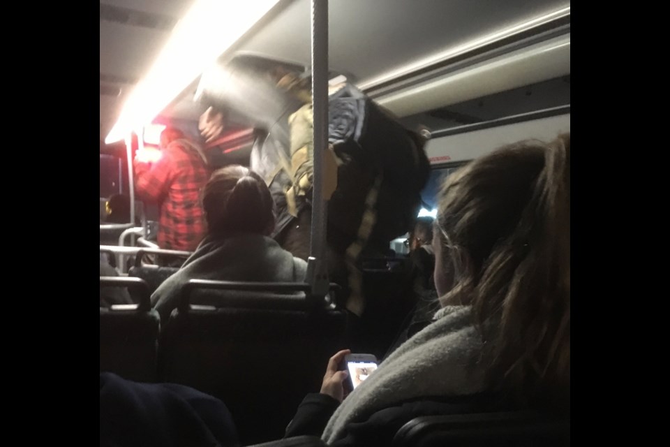Passengers on a B.C. Transit double-decker bus.