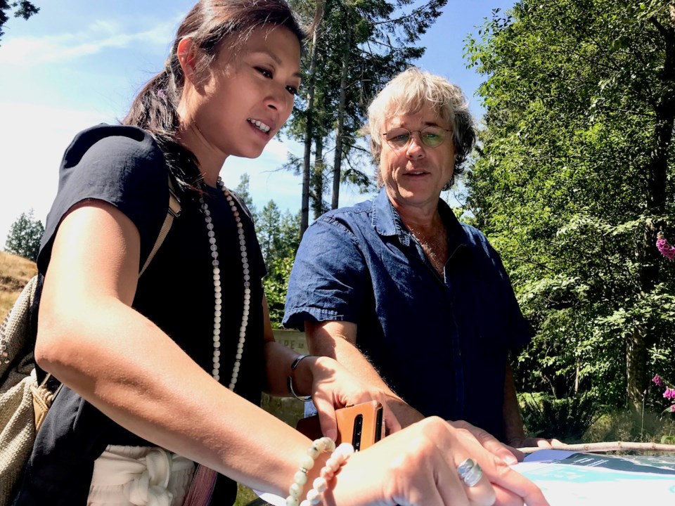 Candy Ho and John Dowler examining a map of Cape Roger Curtis.