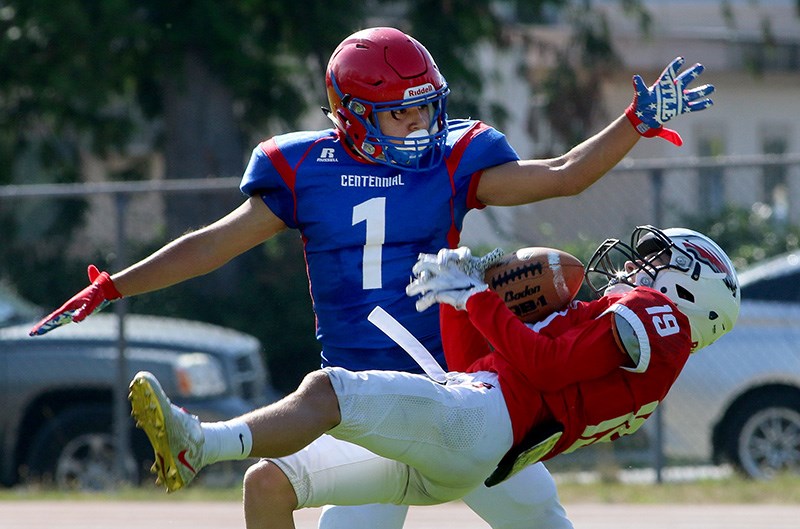 MARIO BARTEL/THE TRI-CITY NEWS
Centennial's Felipe Ruiz tries to knock a pass from a Carson Graham receiver during a recent controlled scrimmage at the Centaurs' home field in Coquitlam.