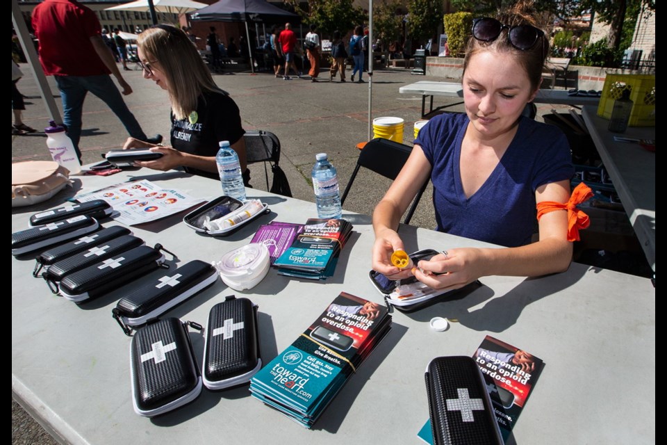 Fourth year University of Victoria nursing students Claire Bruce, right, and Emily Hazlehurst in Centennial Square, where they supplied Naloxone training during International Overdose Awareness Day.