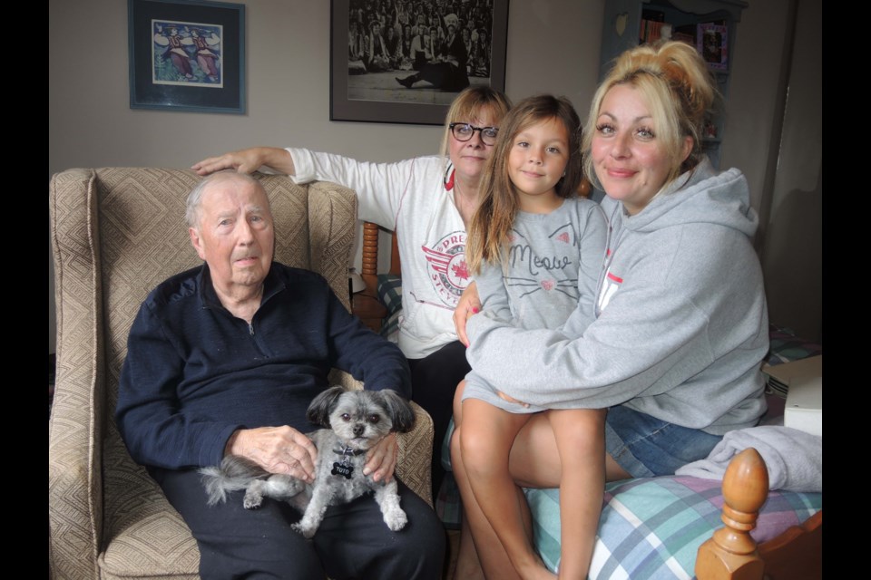 Meros Leckow will turn 100 on Thursday, Sept 5. He is pictured at home with (from left) his dog, Toto, daughter Marcia Leckow, great granddaughter Lilja Rheault and granddaughter Kristin Rheault. Alan Campbell photo