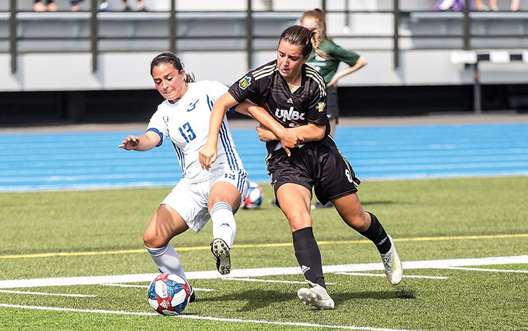 UNBC Timberwolves striker Claire Turner and UBCO Heat midfielder Erica Lampert battle for the ball on Saturday afternoon at Masich Place Stadium in Canada West women’s soccer action. Citizen Photo by James Doyle