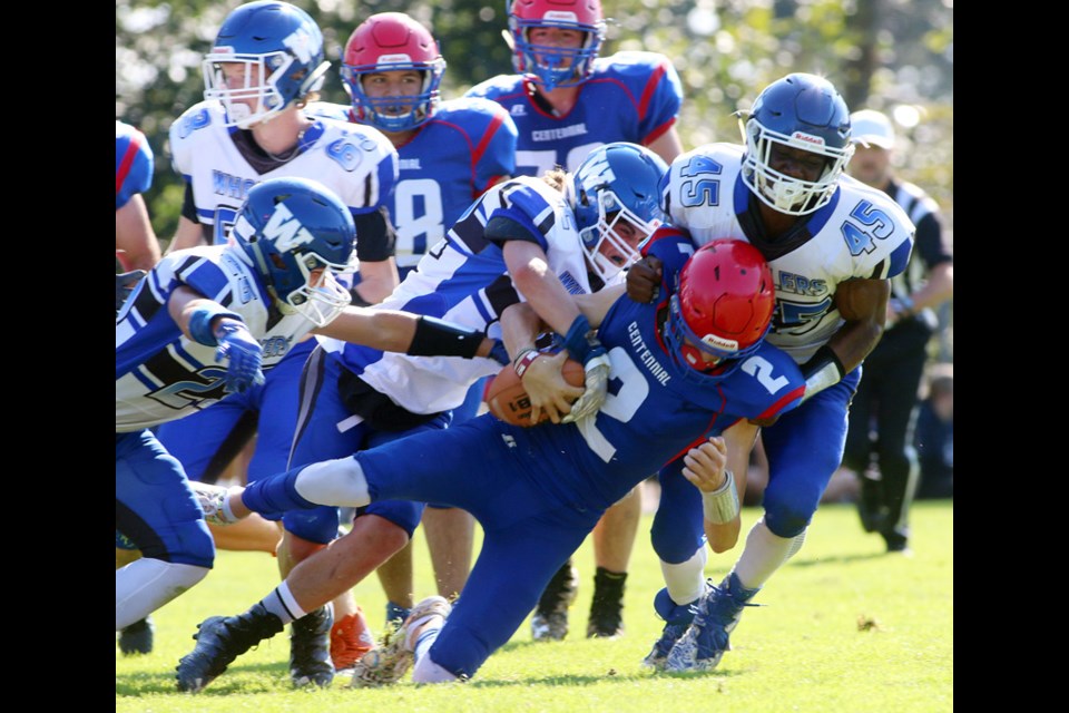 MARIO BARTEL/THE TRI-CITY NEWS
Centennial Centaurs quarterbak Kayle Cowley is brought down by a mob of Ballenas Whalers defenders in the first half of their BC Secondary Schools Football Associaiton AAA senior game, Friday at the Centennial Oval. Ballenas won, 33-21.