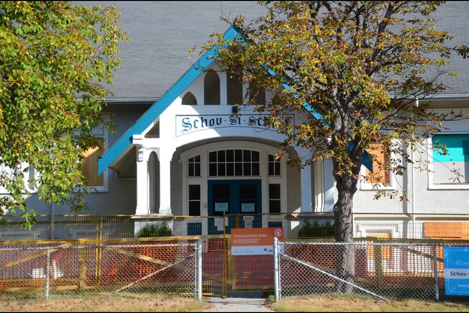 The 1914 Schou Street School building is boarded up behind construction fencing. The heritage structure will be integrated into the school district's new administration offices.