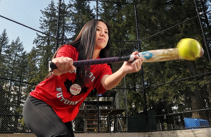 Hunter Lang of the Coquitlam Minor Softball Association demonstrates how to lay down a bunt at Coqui