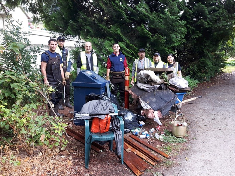 Volunteers with the trash collected by the Hoy-Scott Watershed Society last summer