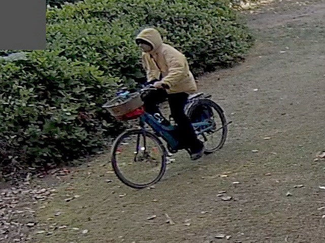 A surveillance photo of the suspect riding away on the stolen e-bike.