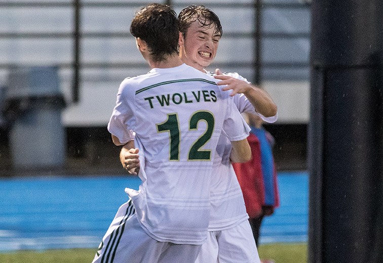 UNBC Timberwolves midfielder Owen Stewart celebrates with teammate Anthony Preston (#12) after scoring the opening goal of the match, and his first of the season, against the Mount Royal University Cougars on Friday night at Masich Place Stadium. Citizen Photo by James Doyle