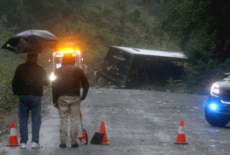 Search and rescue crews and RCMP help a tow-truck crew to remove a bus from an embankment next to a logging road near Bamfield, B.C., on Saturday, Sept. 14, 2019. Two University of Victoria students died and more than a dozen other people were injured after a bus on its way to a marine research centre rolled over on a narrow gravel road on Friday. The incident happened between the communities of Port Alberni and Bamfield, said the Joint Rescue Co-ordination Centre in Victoria, which received a call for assistance at around 10 p.m. THE CANADIAN PRESS/Chad Hipolito