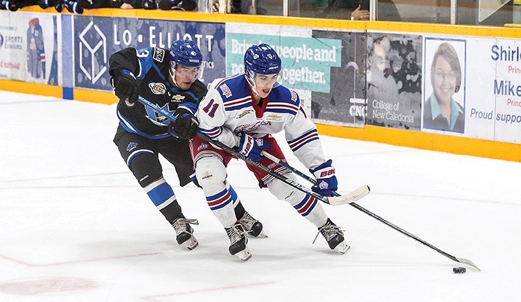 Prince George Spruce Kings forward Brett Pfoh cuts hard to the net while protecting the puck from the check of Penticton Vees defender Evan McIntyre on Saturday night at Rolling Mix Concrete Arena. Citizen Photo by James Doyle