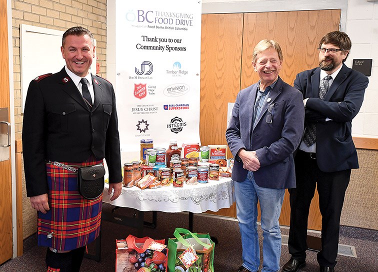 Major Neil Wilkinson with the Salvation Army along with Councilor Murry Krause and Jon Duncan from Church of Jesus Christ of Latter-day Saints at a proclamation signing that September 21 is BC Thanksgiving Food Drive Day. This will be the ninth year for the event that will see paper bags go out across the community to be filled with food items that will be picked up by volunteers. This years goal is to collect between 30,00-35,00 lbs of food locaally. Citizen photo by Brent Braaten