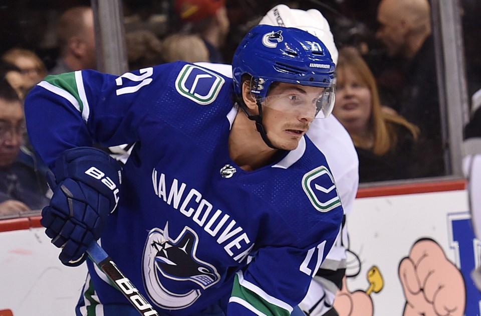 Loui Eriksson battles along the boards for the Vancouver Canucks.