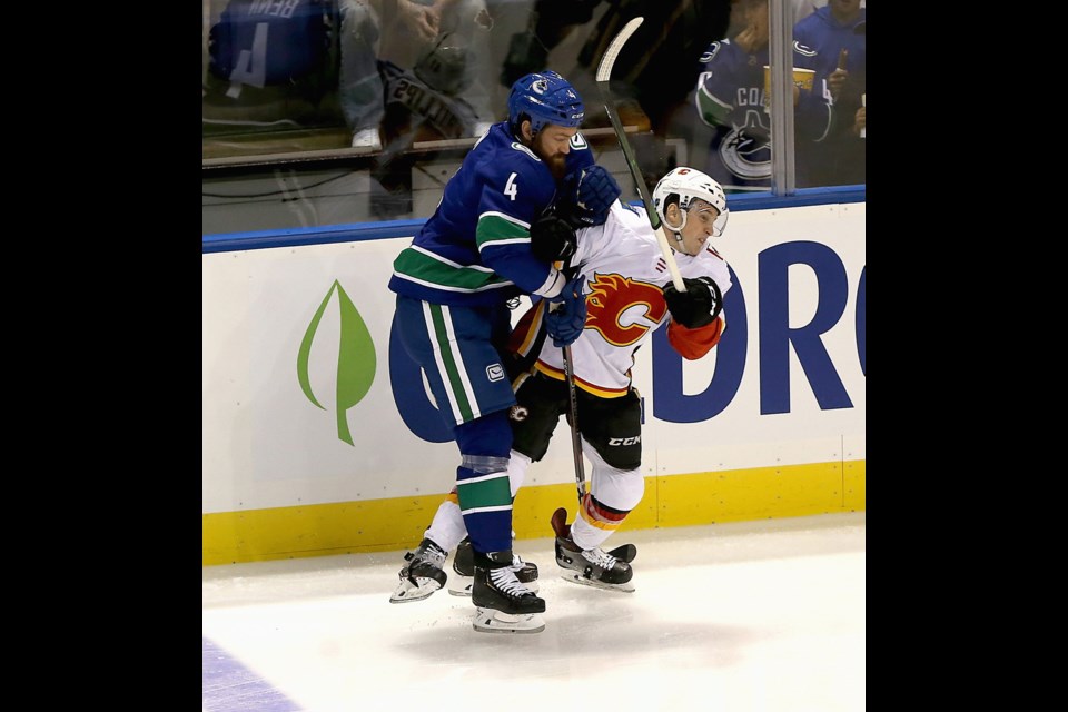 Victoria connection: Vancouver Canucks Jordie Benn, a Victoria native, tangles with Calgary Flames' Matthew Phillips, a Victoria Royals alumni, during their pre-season game at Save-on-Foods Memorial Centre on Monday night. Sept. 16, 2019