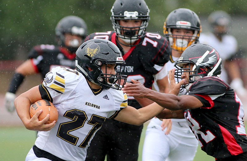 MARIO BARTEL/THE TRI-CITY NEWS Terry Fox Ravens linebacker Ashenafi MacKinley tries to tackle a Kelowna Owls ball carrier in the first half of their BC Secondary Schools Football Association junior varsity game, last Thursday at Coquitlam's Percy Perry Stadium. The juniors lost, 13-12.