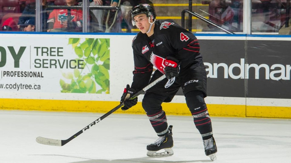 Jett Woo prepares to shoot the puck with the Moose Jaw Warriors.