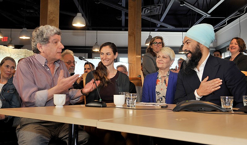 Federal NDP leader Jagmeet Singh listens as Coquitlam restauranteur Fred Soofi, left, talks about so