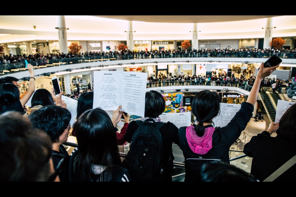 Hundreds of protesters sung together at Aberdeen on Sept. 14 in support of Hong Kong. Photo by Herb Chao