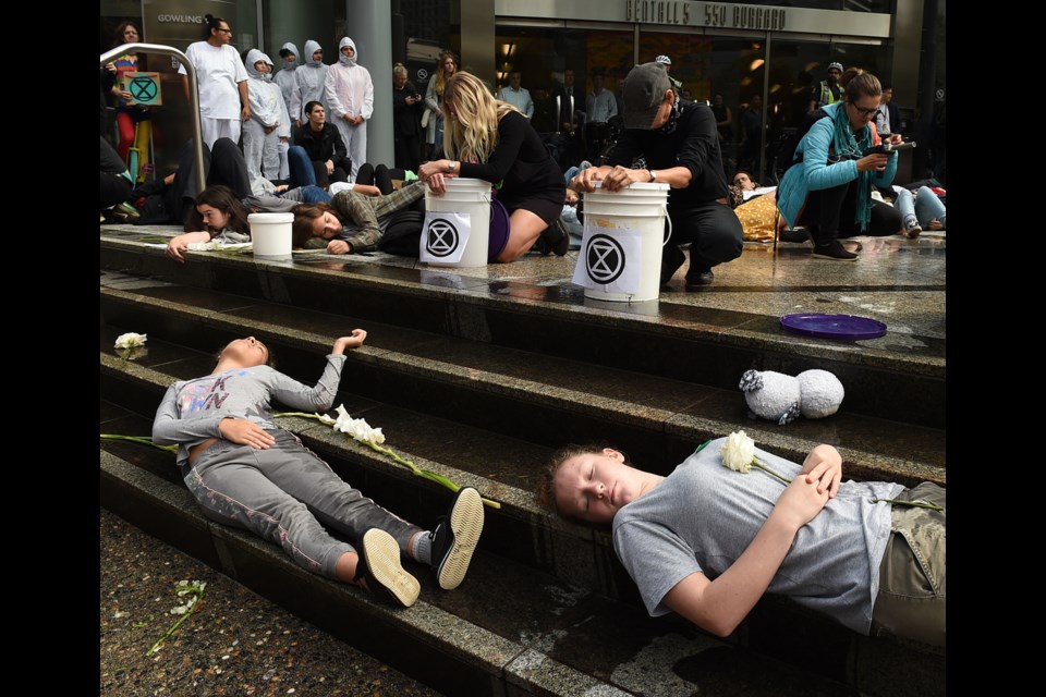 Sustainabiliteens Vancouver held a die-in for action against climate change Friday downtown at different locations, including Teck Resources Ltd., marched to the Vancouver Art Gallery to end their day of protest. Photo Dan Toulgoet