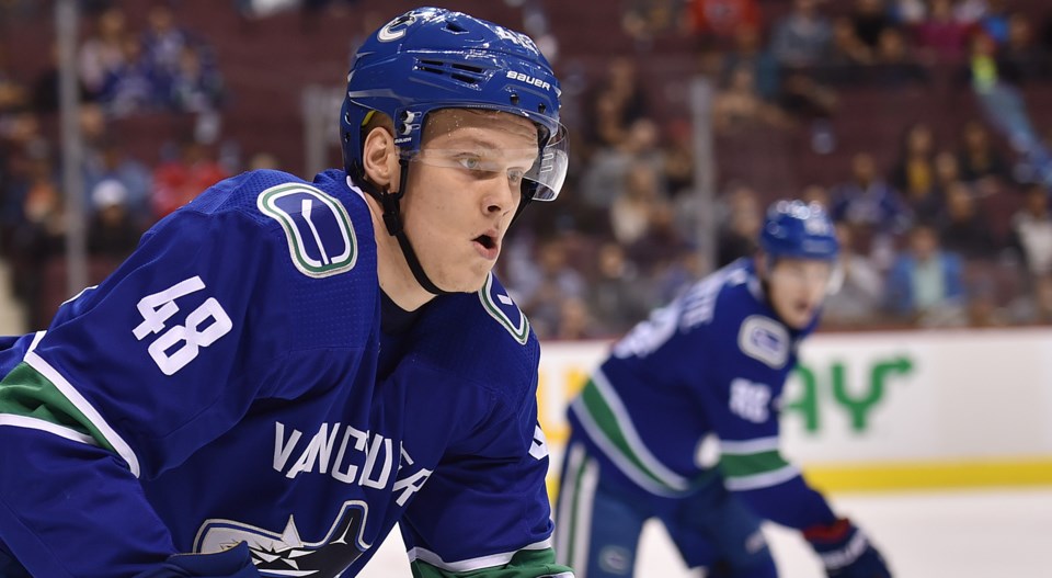 Olli Juolevi chases down the puck for the Canucks in the 2018 preseason.