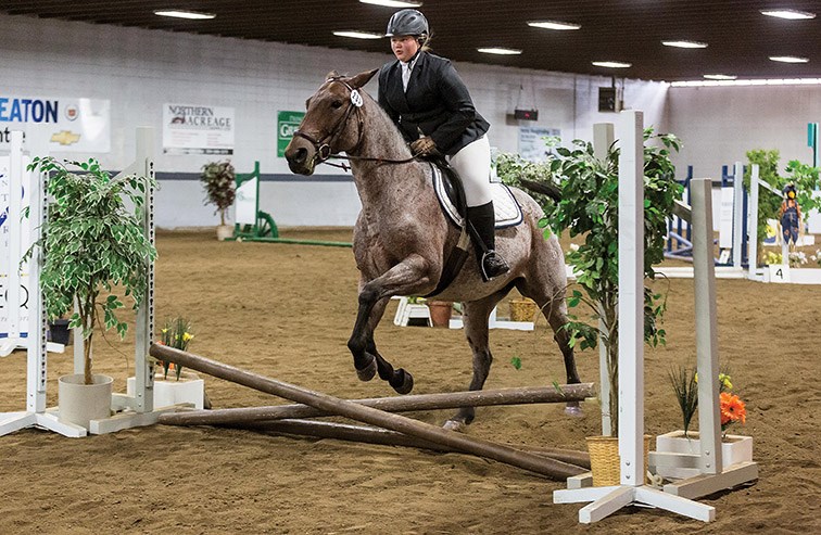 Kyra Snow guides her horse Iced Latte over a rail on Saturday afternoon at Prince George Agriplex while competing in the 6th Annual B.C. Interior Hunter Jumper Association Fall Finale. Citizen Photo by James Doyle