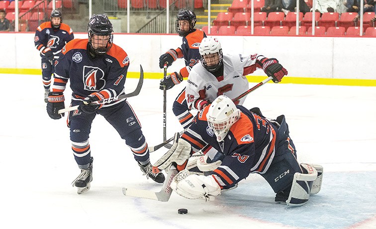 Cariboo Cougars forward Carter Yarish looks to play the loose puck before it is gobbled up by Thompson Blazers goaltender Kobe Grant on Saturday afternoon at Kin 1. Citizen Photo by James Doyle