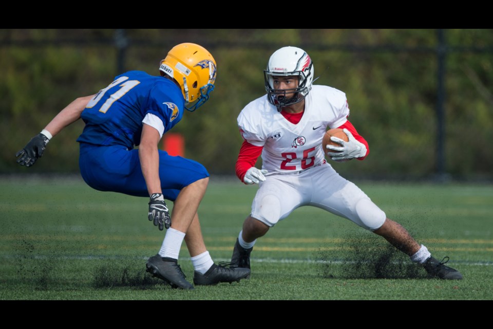 Carson Graham Eagles running back Darius Andrade tries to shake off Handsworth tackler Seb Horak during the annual Buchanan Bowl Saturday at Carson. Andrade rushed for three touchdowns as the Eagles soared to a 55-2 win. photo supplied Blair Shier