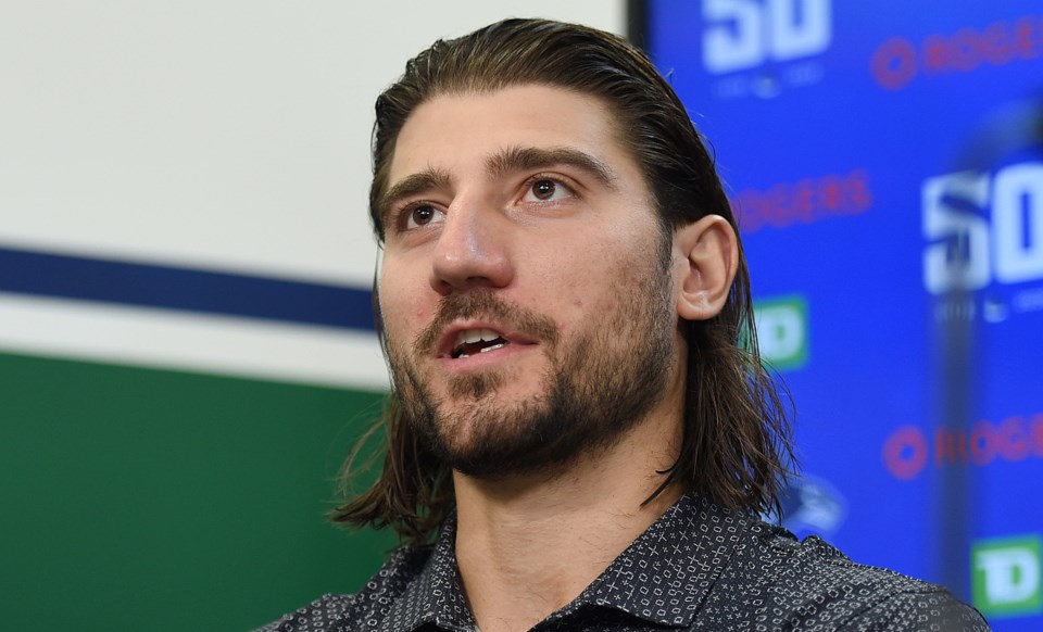 Chris Tanev speaks to the media at the Canucks 2019 media day.