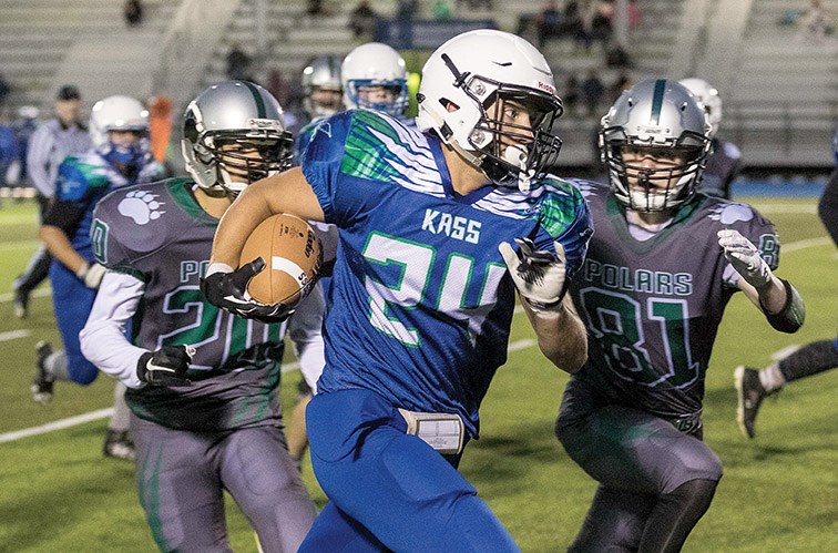 Kelly Road Roadrunners Brendan Watts runs the ball while dodging two PGSS Polars defenders on Thursday evening at Masich Place Stadium. Citizen Photo by James Doyle