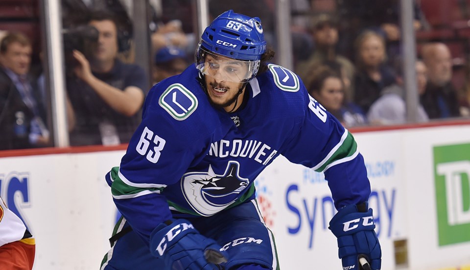 Jalen Chatfield tracks down the puck for the Vancouver Canucks.