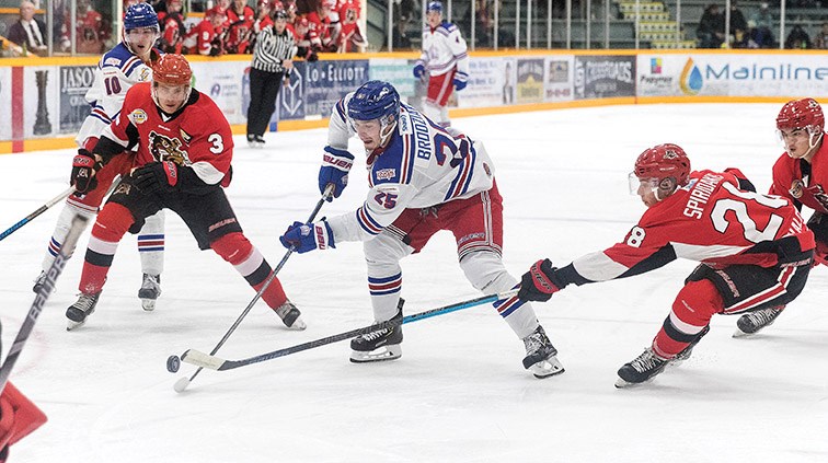 Prince George Spruce Kings forward Preston Brodziak looks to make a play against Alberni Valley Bulldogs defender Austin Spiridakis on Friday night at Rolling Mix Concrete Arena. Citizen Photo by James Doyle