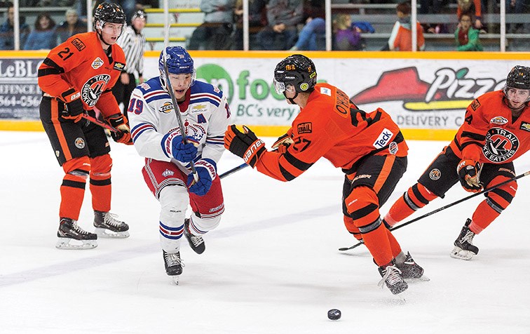Prince George Spruce Kings forward Chong Min Lee chases the loose puck while being checked by Trail Smoke Eaters defender Kieran O’Hearn on Saturday evening at Rolling Mix Concrete Arena. Citizen Photo by James Doyle