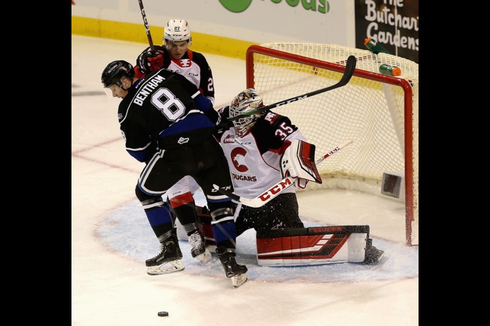 Victoia Royals forward Nolan Bentham (8) runs interference in front of Prince George Coygars goalie Taylor Gauthier and devenceman Rhett Rhinehart during Friday's WHL game in Victoria.