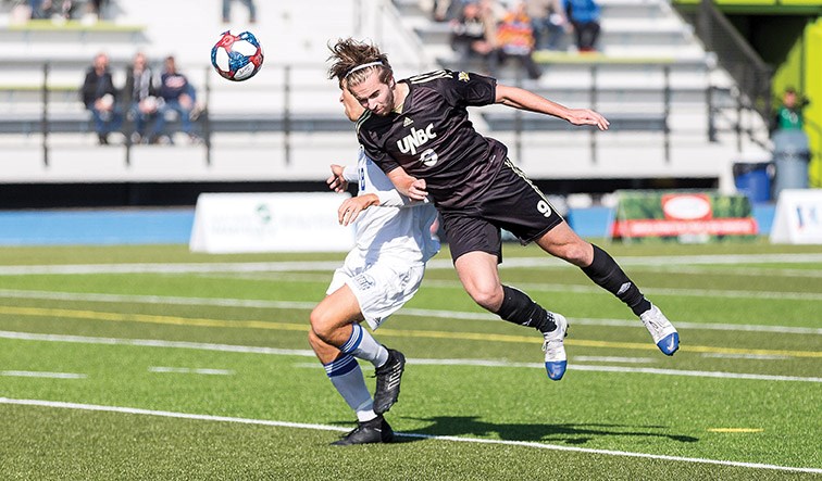 UNBC Timberwolves forward Michael Henman leaps to make a header against UBC Thunderbirds defender Riley Pang on Sunday afternoon at Masich Place Stadium. Citizen Photo by James Doyle