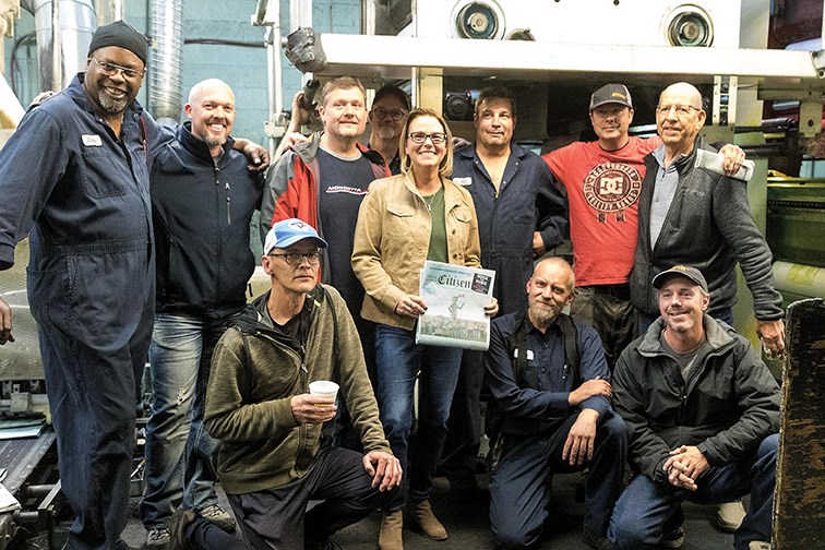 A group of current and former Prince George Citizen pressmen stand with publisher Colleen Sparrow who is holding the final copy of the daily edition of the Prince George Citizen newspaper on Friday evening at the Citizen press building. Citizen Photo by James Doyle