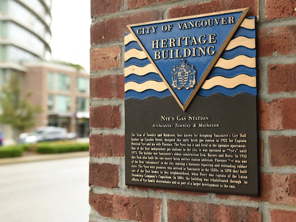 A plaque indicates a building is protected by municipal heritage designations or a legal agreement.