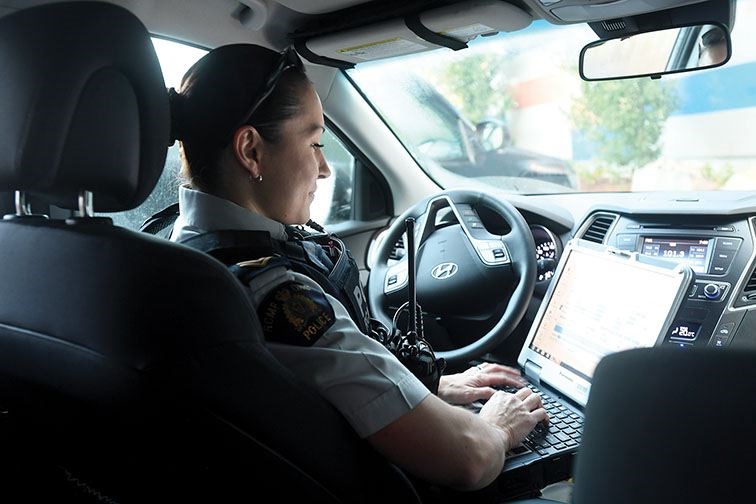 Cpl. Sonja Blom logs into her computer prior to hitting the streets last Thursday morning.
