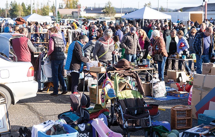 Bargain hunters check out items at REAPS Junk in the Trunk sale on Saturday morning at the Exhibition Park parking lot. Citizen Photo by James Doyle