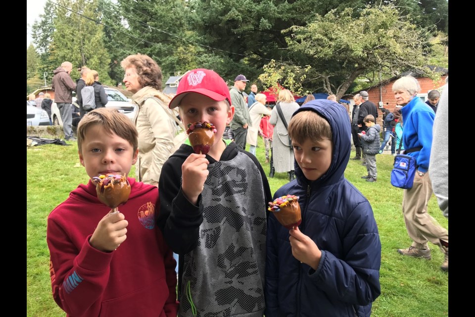 Denis Cormier (in the red hat) and a couple of friends were among the caramel apple aficionados.