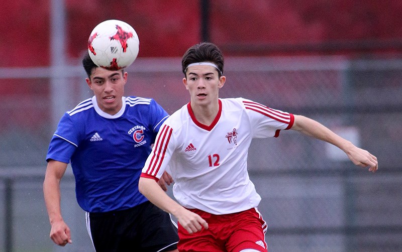 MARIO BARTEL/THE TRI-CITY NEWS
Coquitlam Centennials' Ethan Solito and Terry Fox Ravens' Jacob Milton chase down a loose ball in the second half of their Fraser Valley North Athletic Association senior boys soccer match, Monday at Gates Park in Port Coquitlam. The Ravens won, 2-1. Andrew Cerqueira and Rio Yoshida scored for Fox, while Dante Bandiera replied for Centennial.